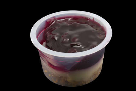 Cheesecake cupcake topped with blueberries isolated on blackの写真素材