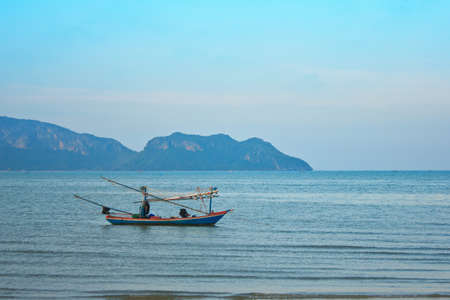 a fishing boat on the sea with blue skyの写真素材