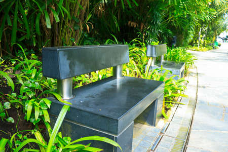 black stone bench in the garden .の写真素材