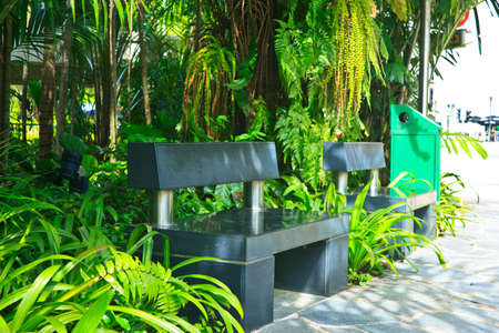 black stone bench in the garden .の写真素材