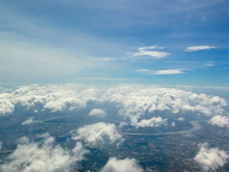 city under high blue sky with white cloudsの写真素材
