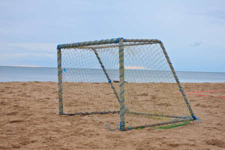 Soccer goal on beach with blue sky の写真素材