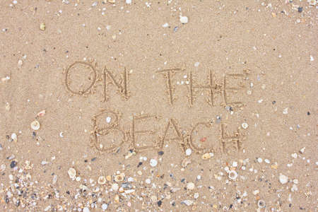 Write " ON THE BEACH " on sandの写真素材