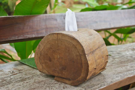 Tissue paper box made from log on old wooden table の写真素材