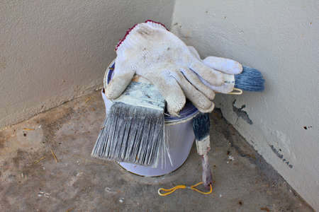 set of painter tool front of old white wallの写真素材
