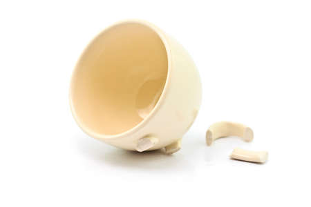 Broken white cup on a white backgroundの写真素材
