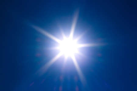 Shining sun at clear blue sky with copy space の写真素材
