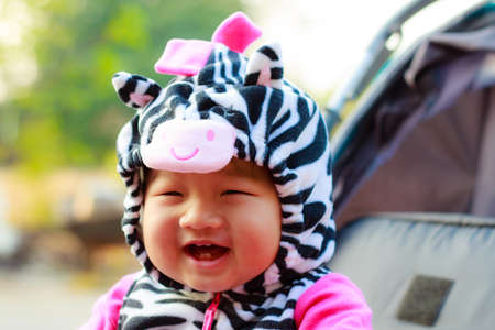 Happy young baby sitting in the baby carriageの写真素材