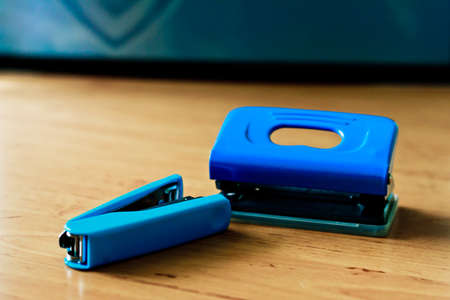 Hole punchers and stapler on the table.