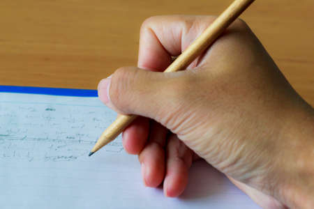 hand writing by pencil on the notebookの写真素材