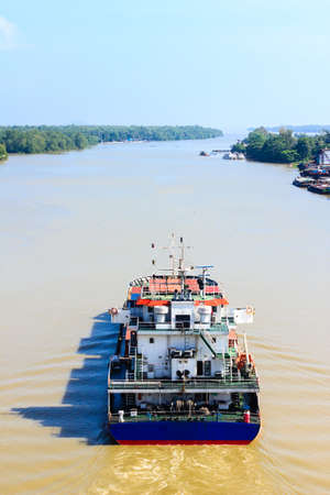 A container ship departure from port on a very calm day.の写真素材