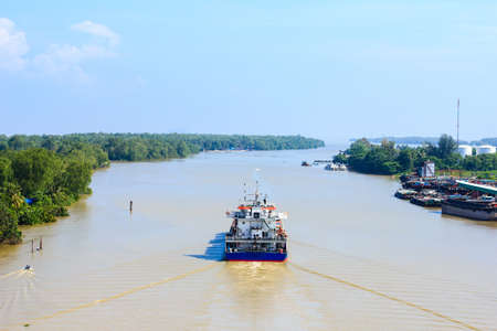 A container ship departure from port on a very calm day.
