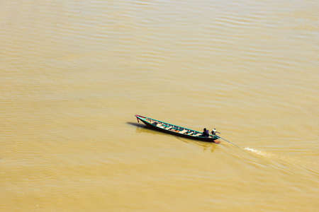 Thai style speeding boat across a lake の写真素材