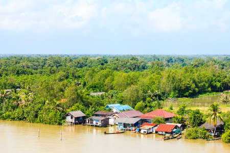 Wooden house on the river bank, rainy seasonのeditorial素材