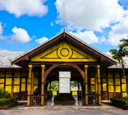  old yellow building against blue cloudy sky の写真素材