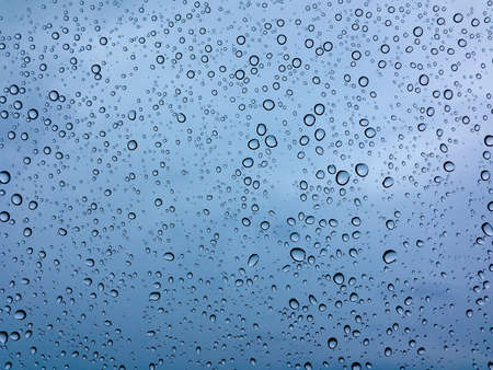 Many drops of rain on the glassの写真素材