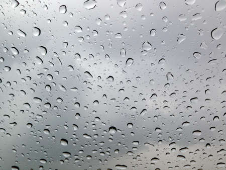 Many drops of rain on the glassの写真素材