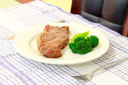 juicy bbq  steak with  brocolli on white dishの写真素材
