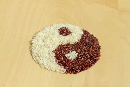 Black and white rice forming a yin yang symbolの写真素材