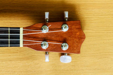 An ukulele on wood background , small guitarの写真素材