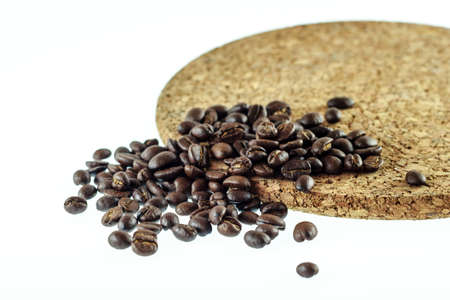 Coffee beans and circle wood on white backgroundの写真素材