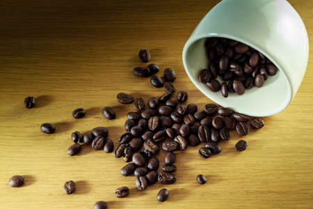 Coffee Bean and cup on wood tableの写真素材