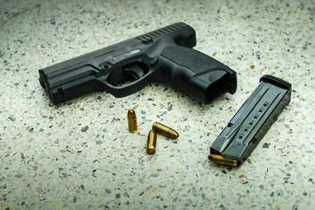 Gun with magazine and ammo on floor