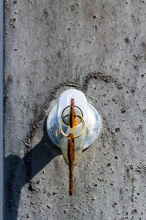 Close-up shot of an old rusty key inside a keyholeの写真素材