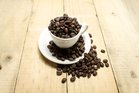 white cup of coffee on wooden tableの写真素材