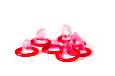 Group of red  condoms on white background