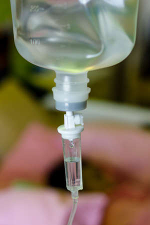Close up saline  drip for patient and Infusion pump in hospital.