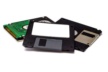 Floppy disk and hard disk on white background