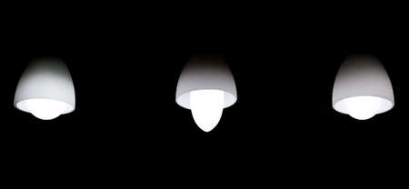 The dark room with three light bulbsの写真素材