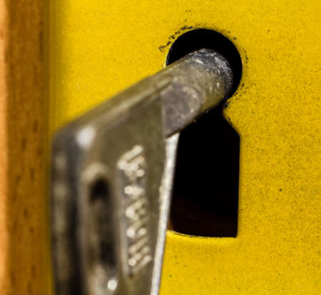 old rusty key is sitting in the door eye.