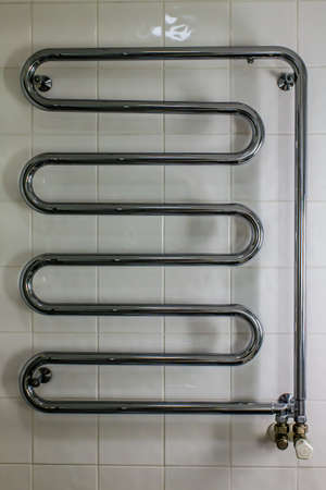 electric heater on a white wall in bathroomの写真素材