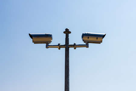 The Security camera on blue sky backgroundの写真素材