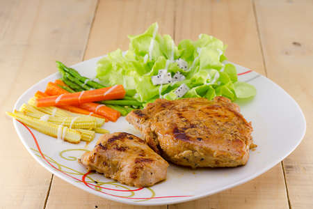 Grilled steaks on white dish with saladの写真素材