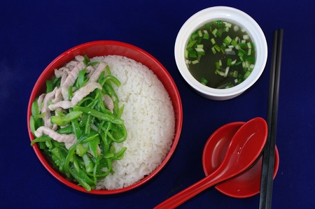 Chinese fast food with green pepeer and riceの写真素材