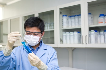 An Analyst is observing a chemical tubeの写真素材