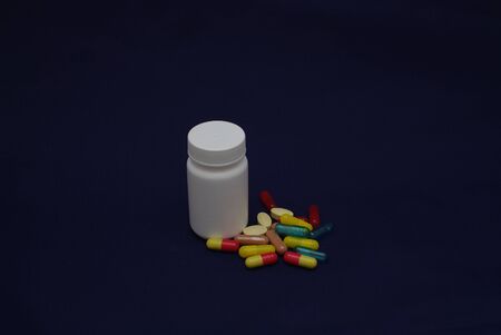 colorful capsules and pills with packaging on pure backroundの写真素材