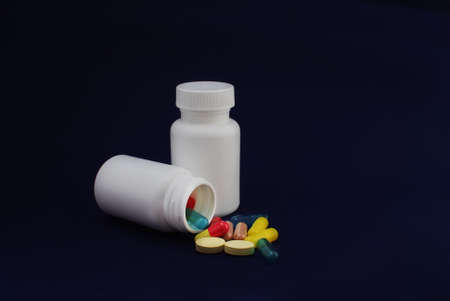 colorful capsules and pills with packaging on pure backroundの写真素材