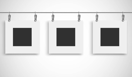 Blank picture frame hanging on a wire rope with metallic clipのイラスト素材