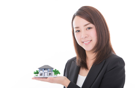 Real estate agent woman with house modelの写真素材