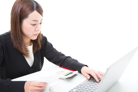 Young woman calculating billsの写真素材