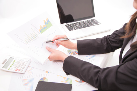 Businesswoman pointing at business graph information diagramの写真素材