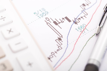 Stock market graph with calculator and penの写真素材