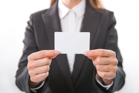 Business woman holding white business cardの写真素材