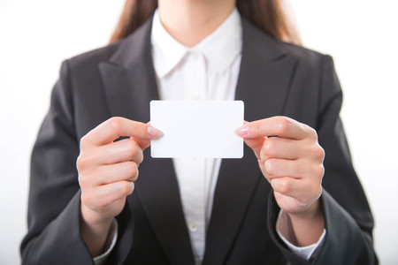 Business woman holding white business cardの写真素材