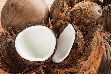 Two pieces of coconut on brown shellの写真素材