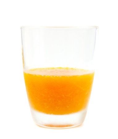 Cold orange juice in glass on white bakgroundの写真素材